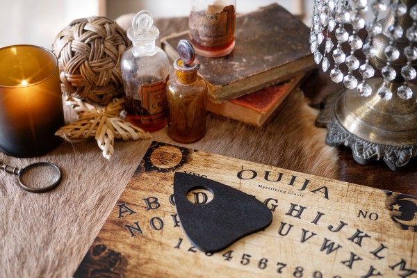 High angle ouija board and old books