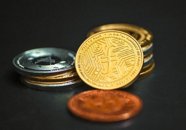 A gold Filecoin leaning on other coins