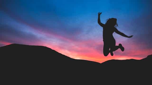 A girl jumping during dawn