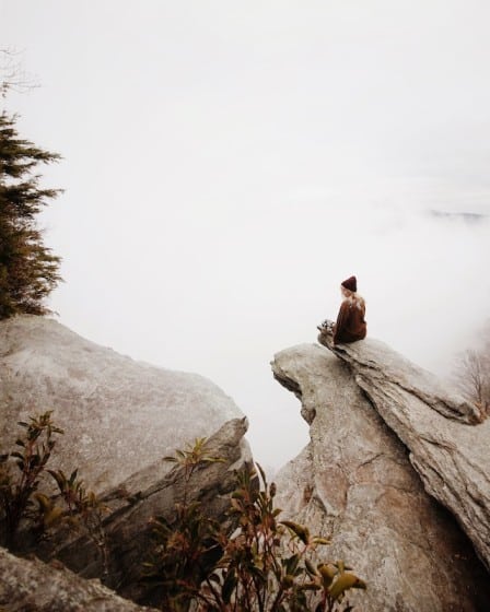 Woman sitting on the rock edge