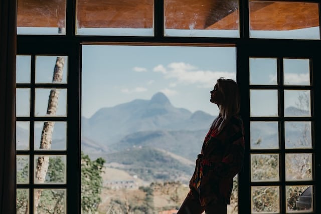 A girl standing while looking at the mountains