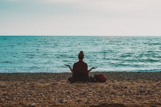 A girl doing yoga at the sea shore